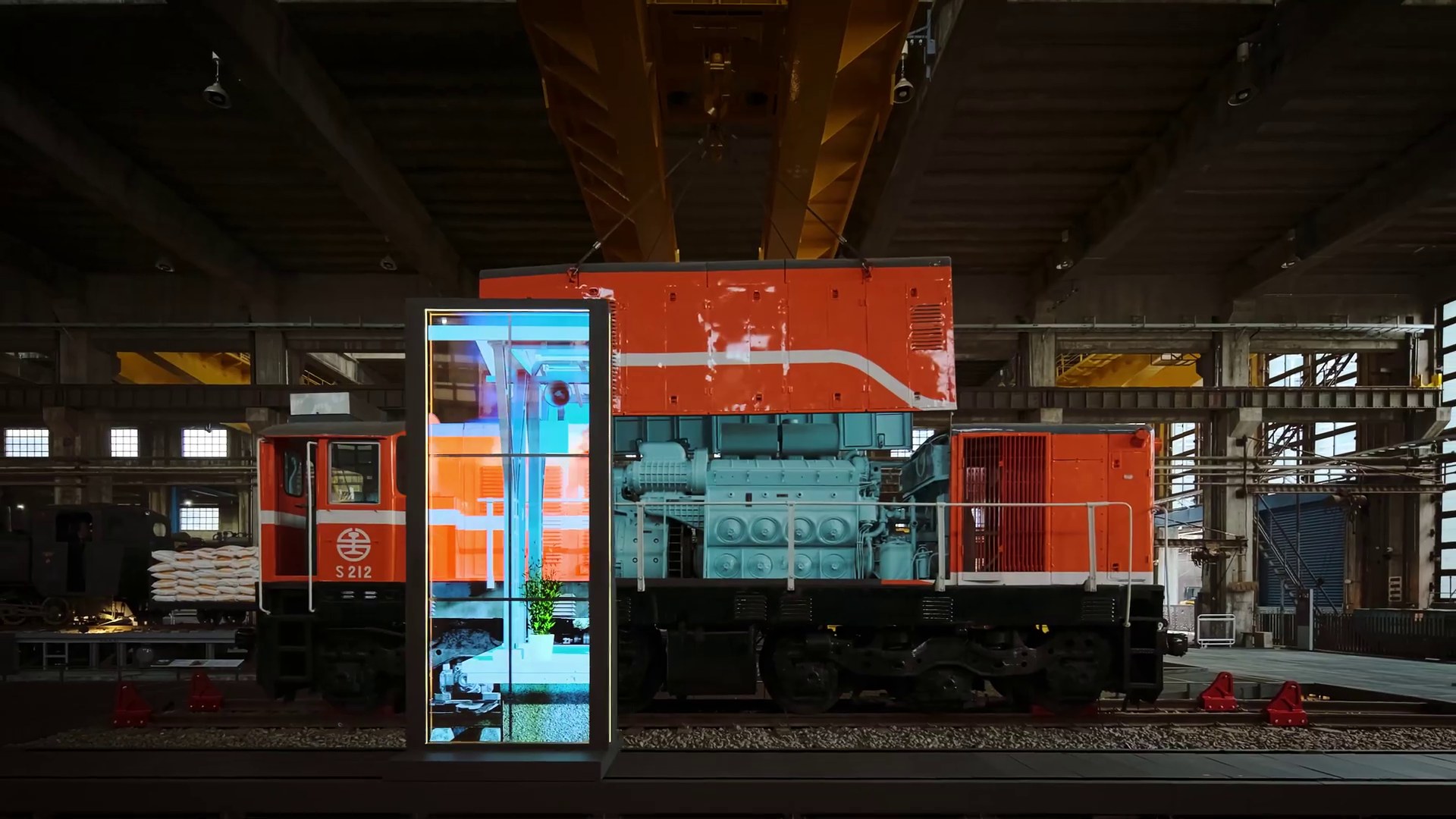 Transparent screen on the carriage, its cross-section registered to locomotive S212 behind it